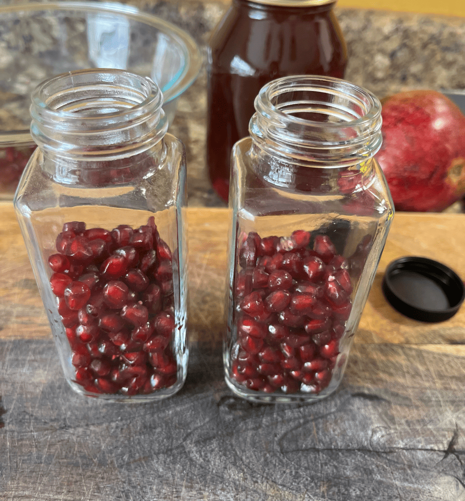 antioxidant packed pomegranate seeds in a glass jar