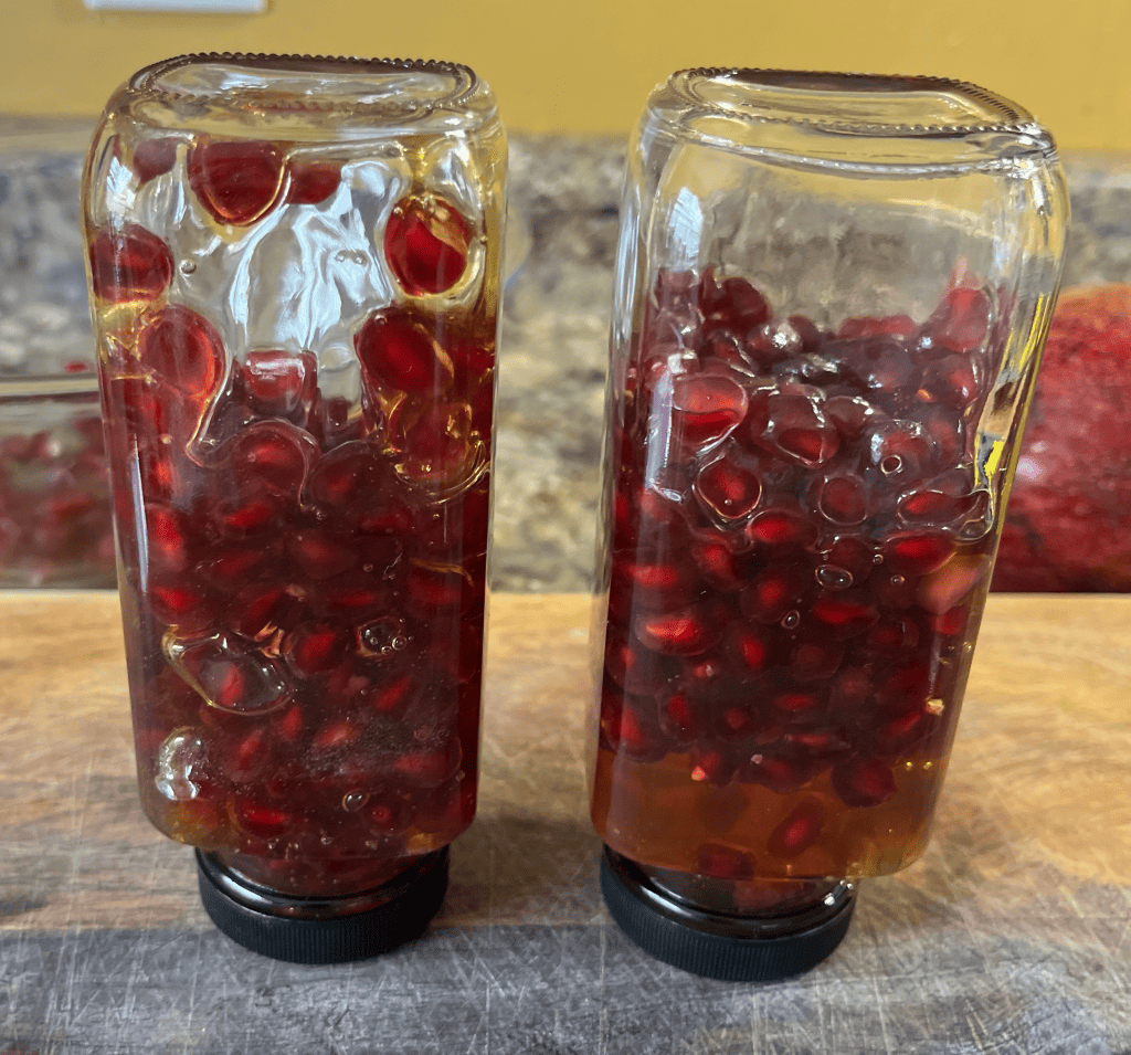 upside down jar of honey fermented pomegranate seeds