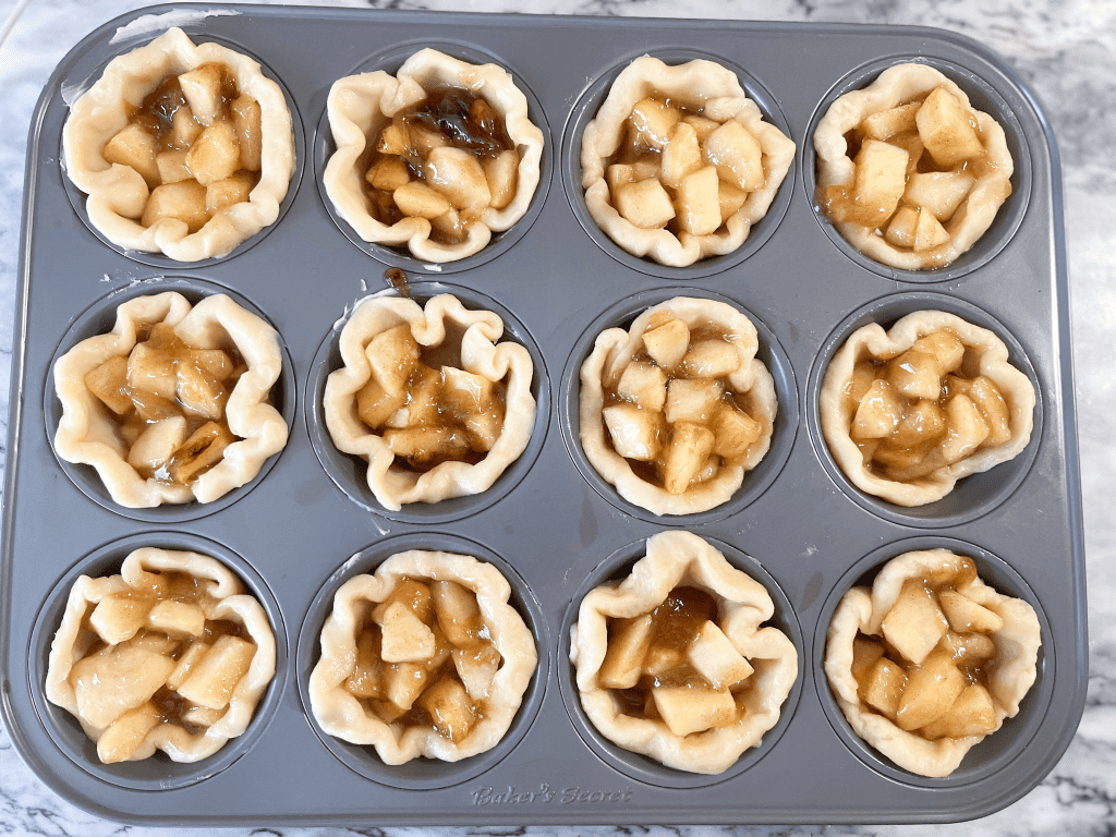 mini apple pies in a muffin tin