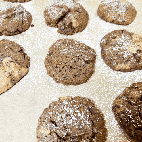 Peanut butter and chocolate chip chickpea cookies sprinkled with powdered sugar