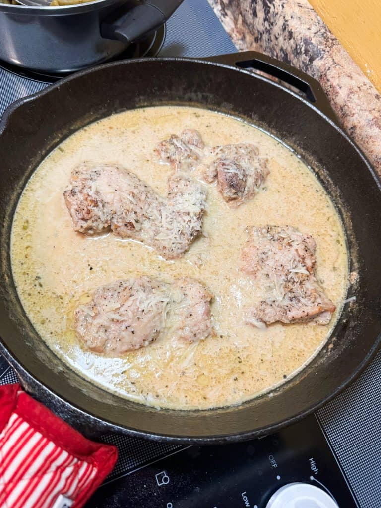 creamy lemon garlic chicken in a cast iron skillet