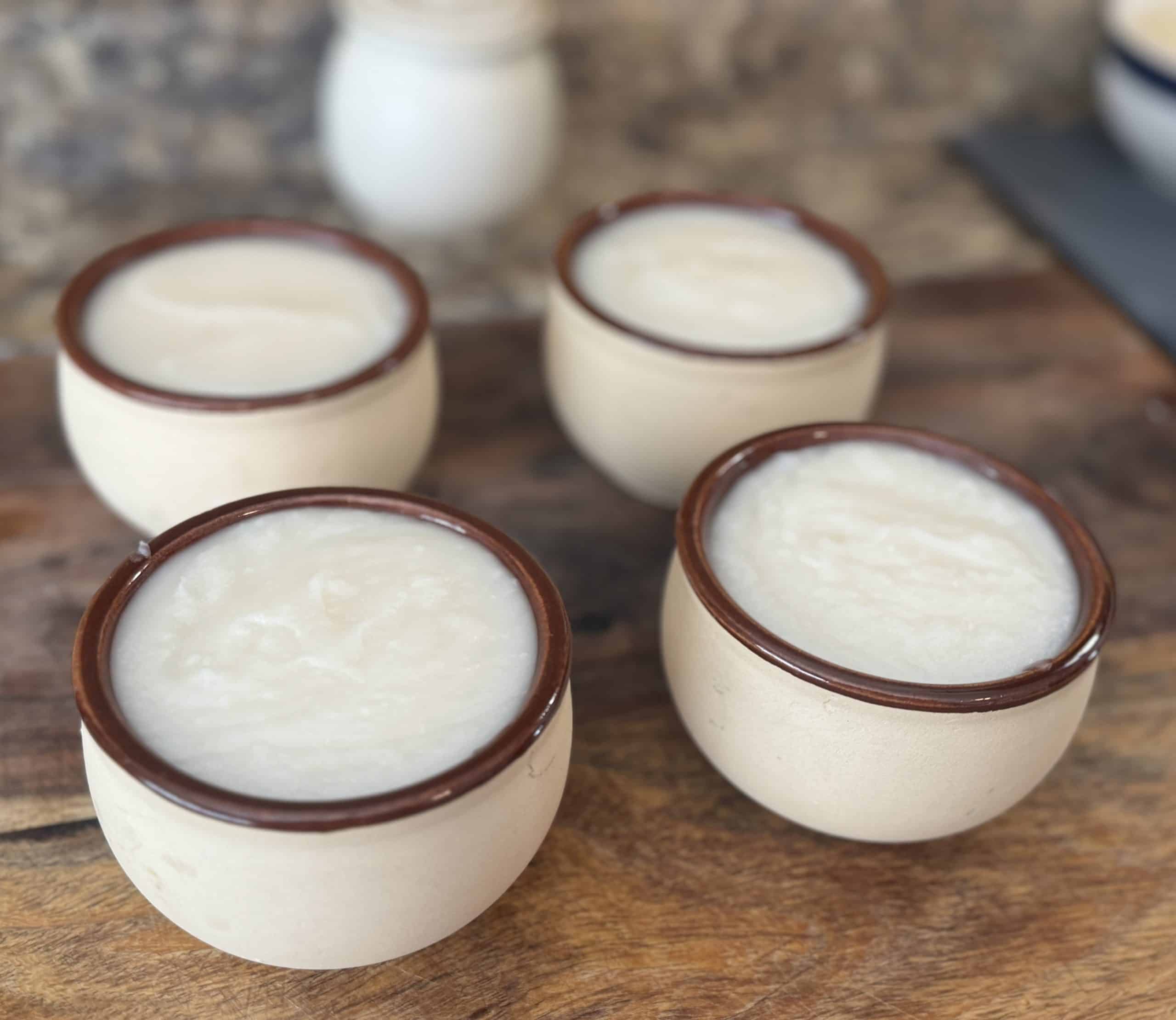 homemade dish soap in thrifted bowls on a wood board
