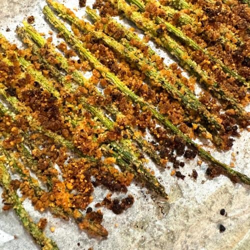 Oven-Baked Crispy Parmesan Asparagus Fries ready to eat sitting on parchment paper