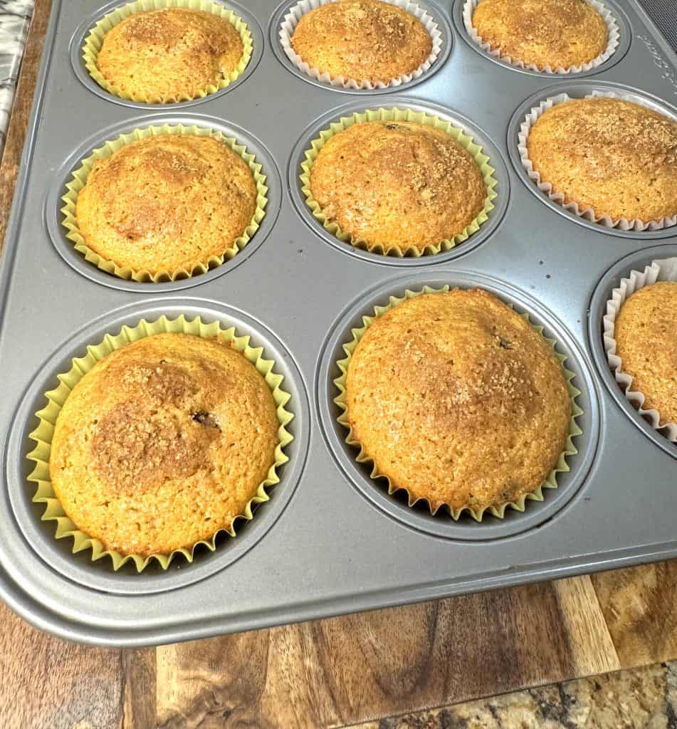 cinnamon raisin muffins fresh out of the oven in a muffin tin