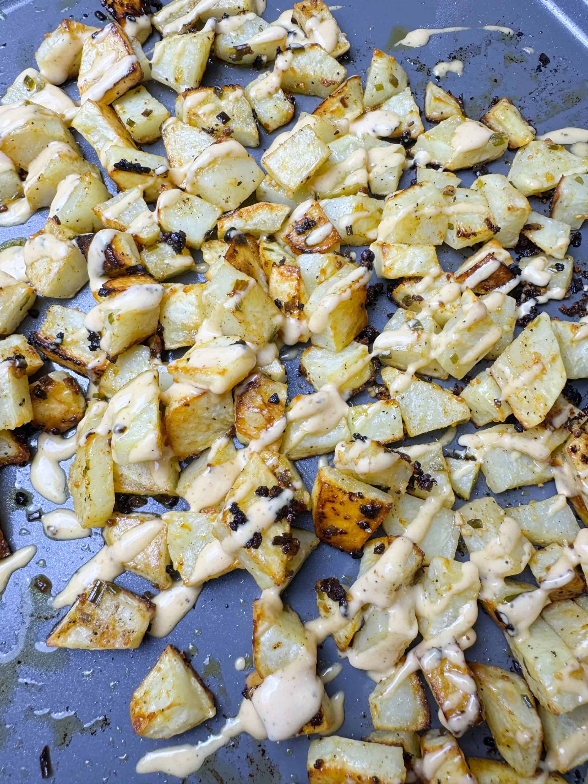 crispy bang bang potatoes on a baking sheet