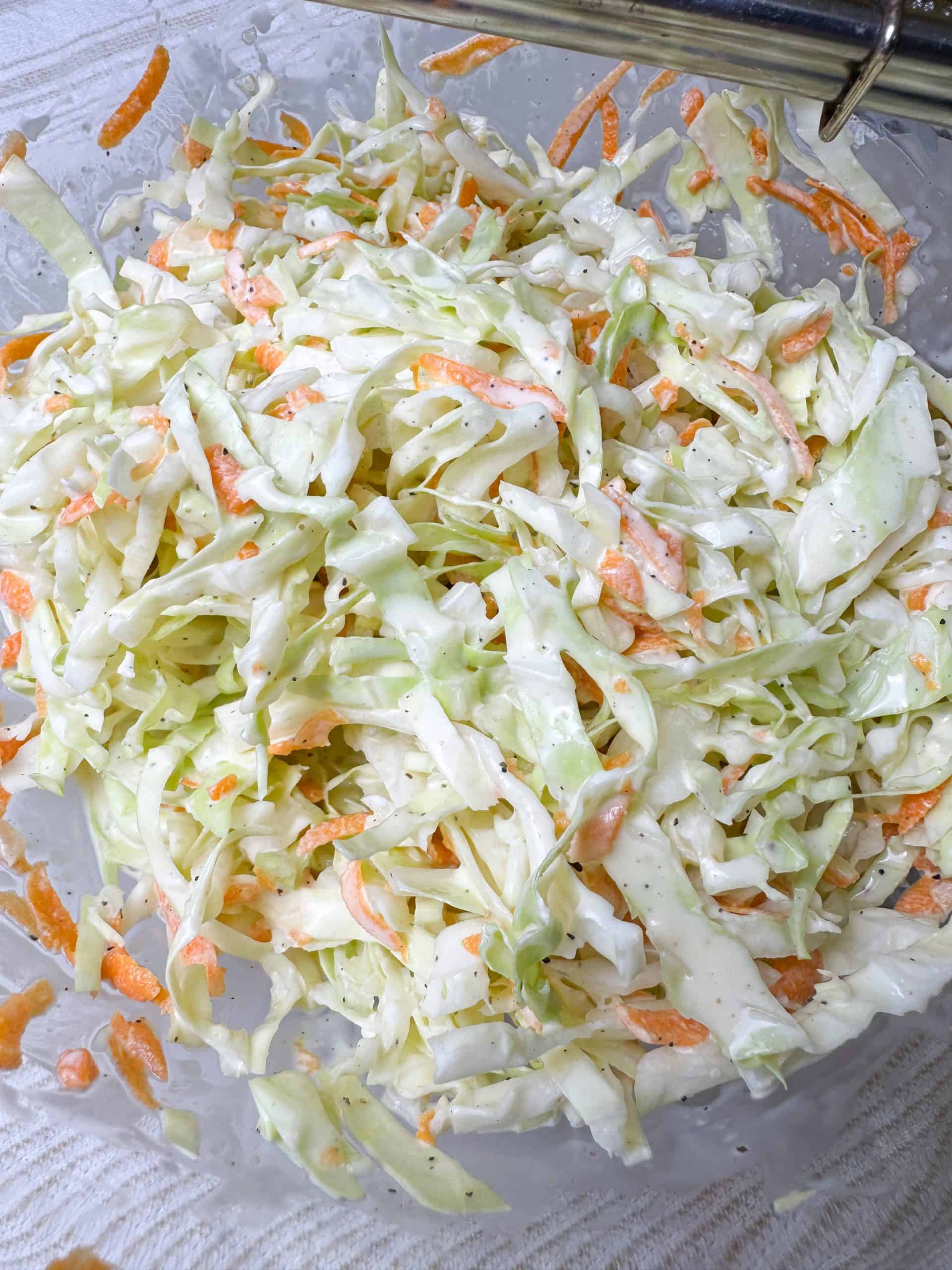 Homemade coleslaw in a large glass bowl
