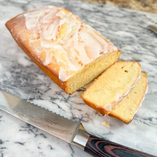 Glazed Sourdough Lemon Cake on a marble pastry board