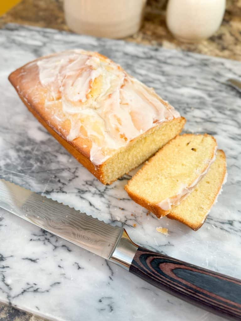 Glazed Sourdough Lemon Cake on a marble pastry board