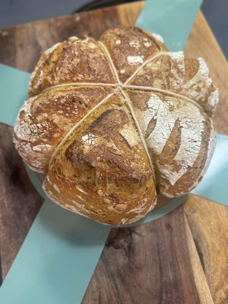 sourdough pumpkin bread on a bread sling fresh out of the oven