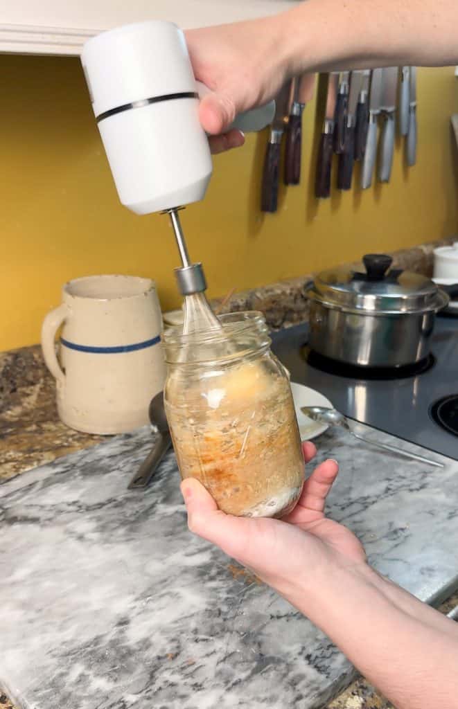 using a hand mixer to whisk together the ingredients of homemade cinnamon sugar butter