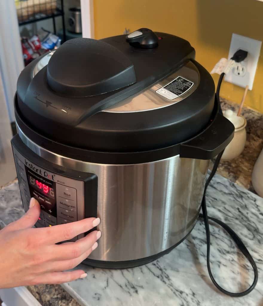 setting the instant pot timer to 15 minutes to pressure cook the Instant Pot Creamy Garlic Mashed Potatoes