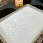 homemade washing soda spread out on a cooking sheet