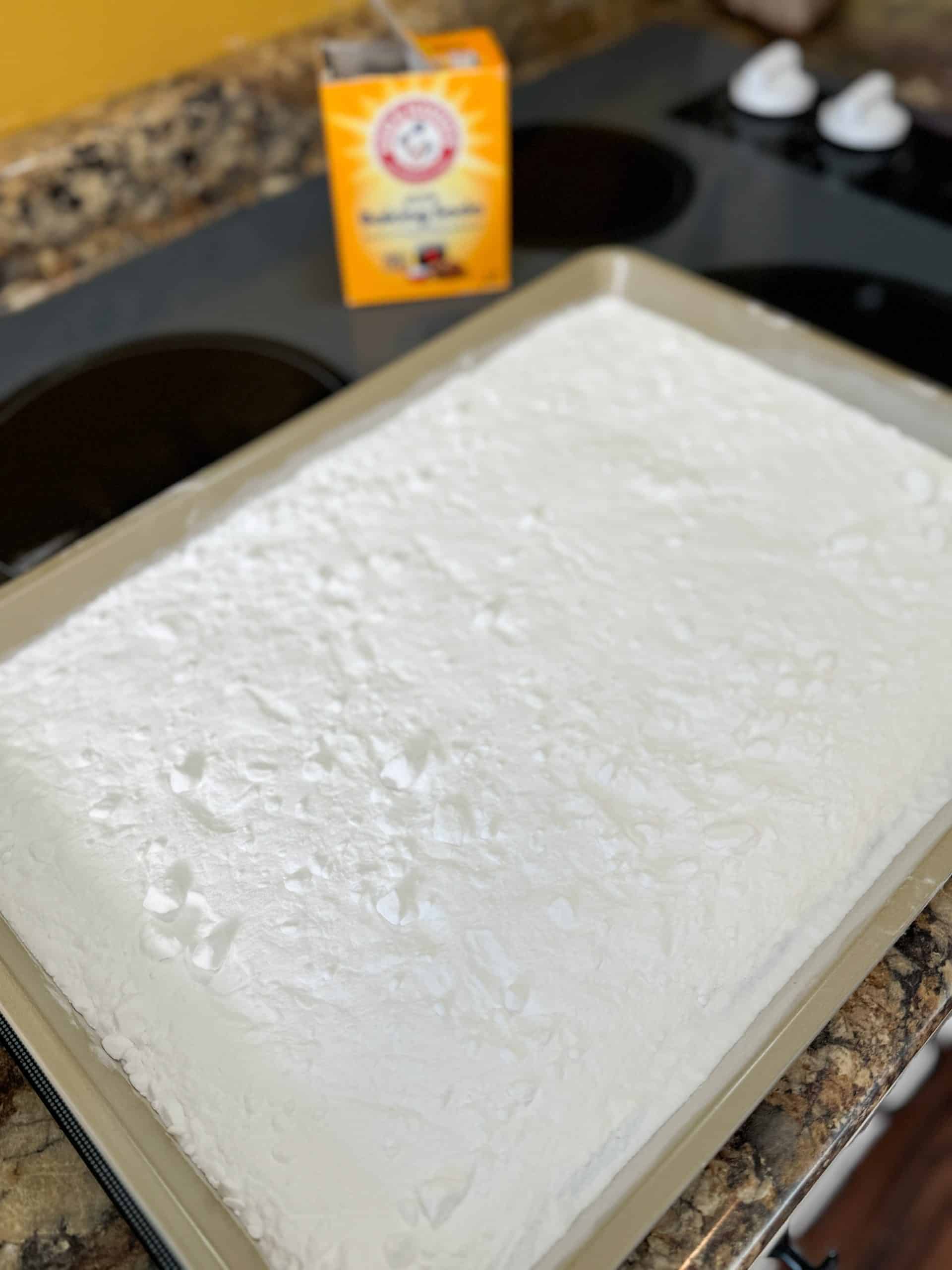 homemade washing soda spread out on a cooking sheet