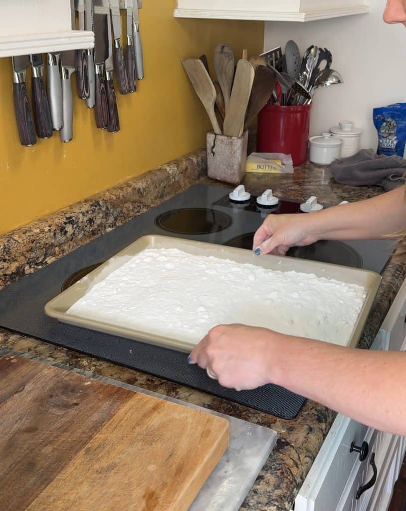 spreading the washing soda out evenly across a cooking sheet