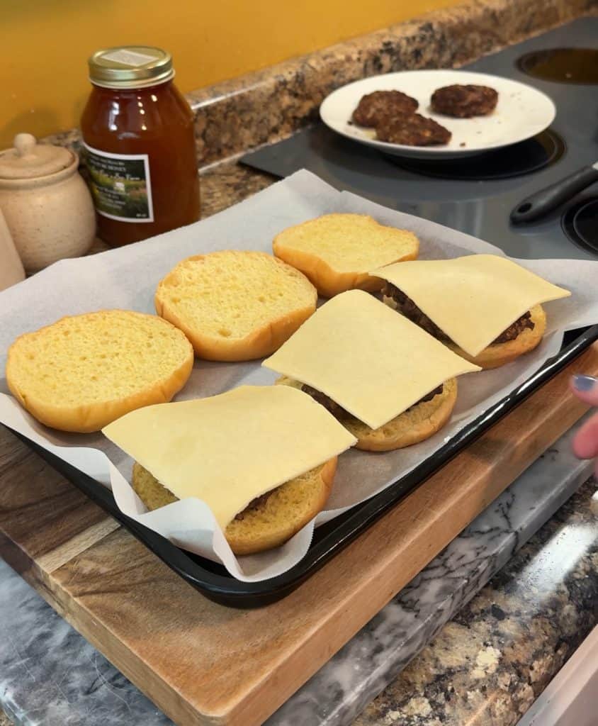 fresh gouda cheese placed on top of the old fashioned hamburgers on buns
