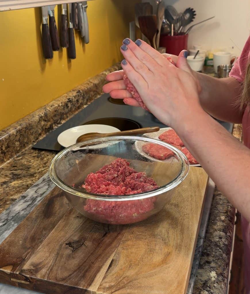 two hands forming hamburger patties