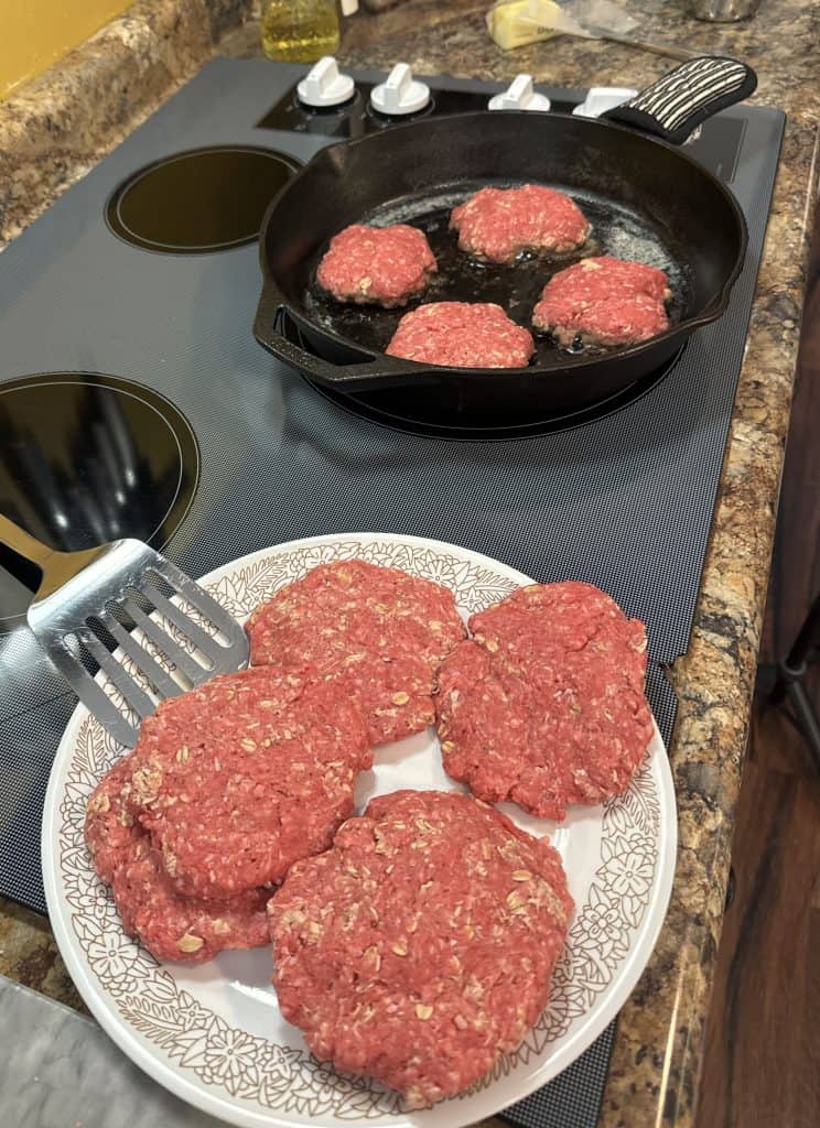 old fashioned hamburgers being cooked low and slow in a cast iron skillet