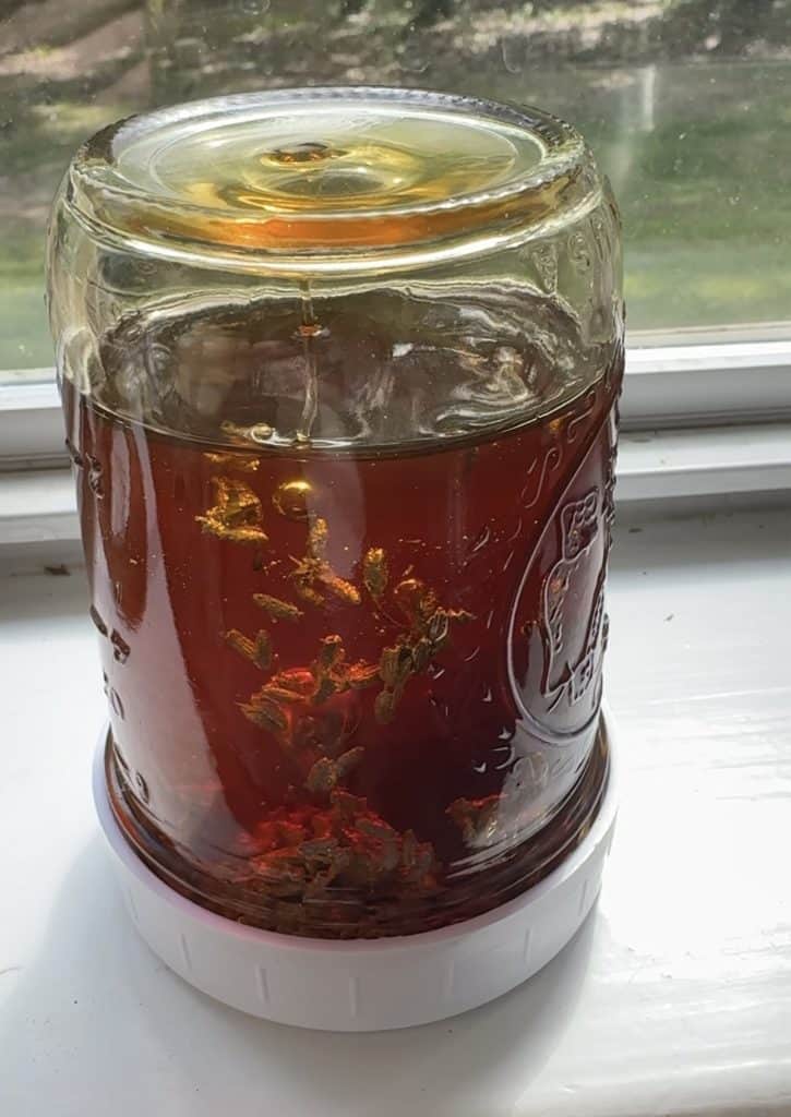 lavender infused honey steeping in a windowsill