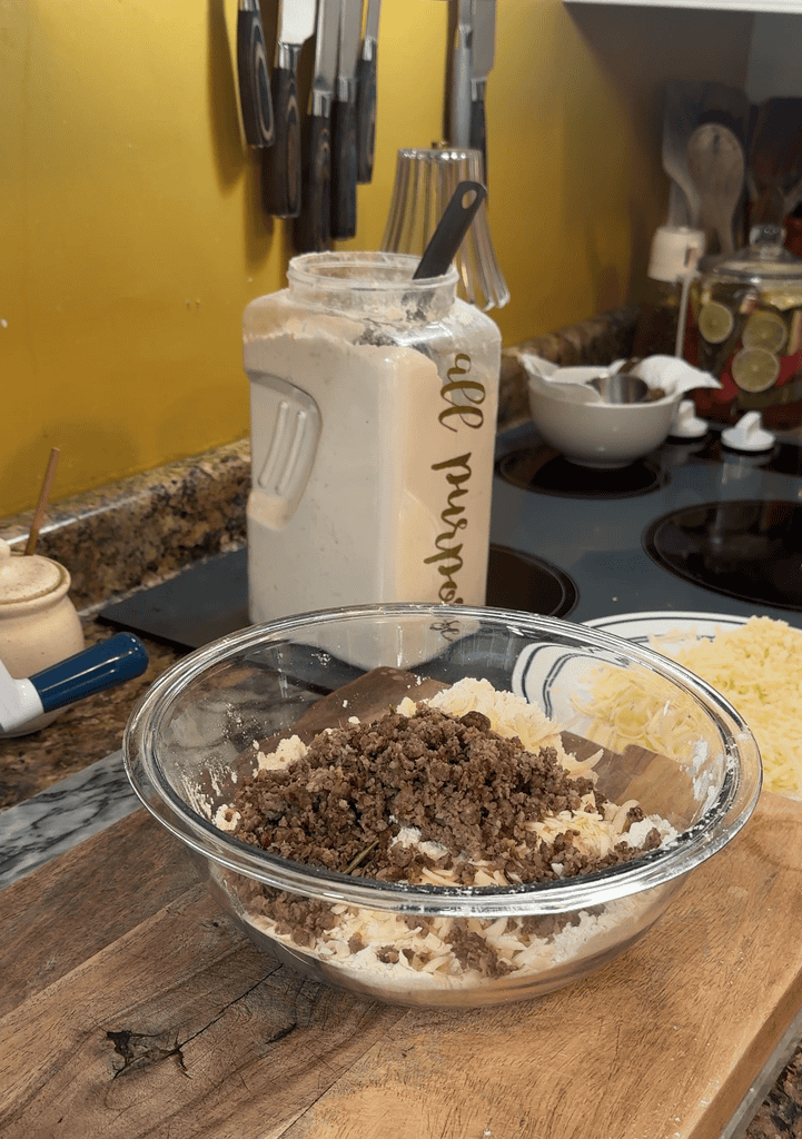 adding sausage to the scone mixture