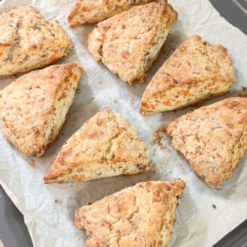 cheesy sausage and rosemary scones cooked golden brown placed on parchment paper