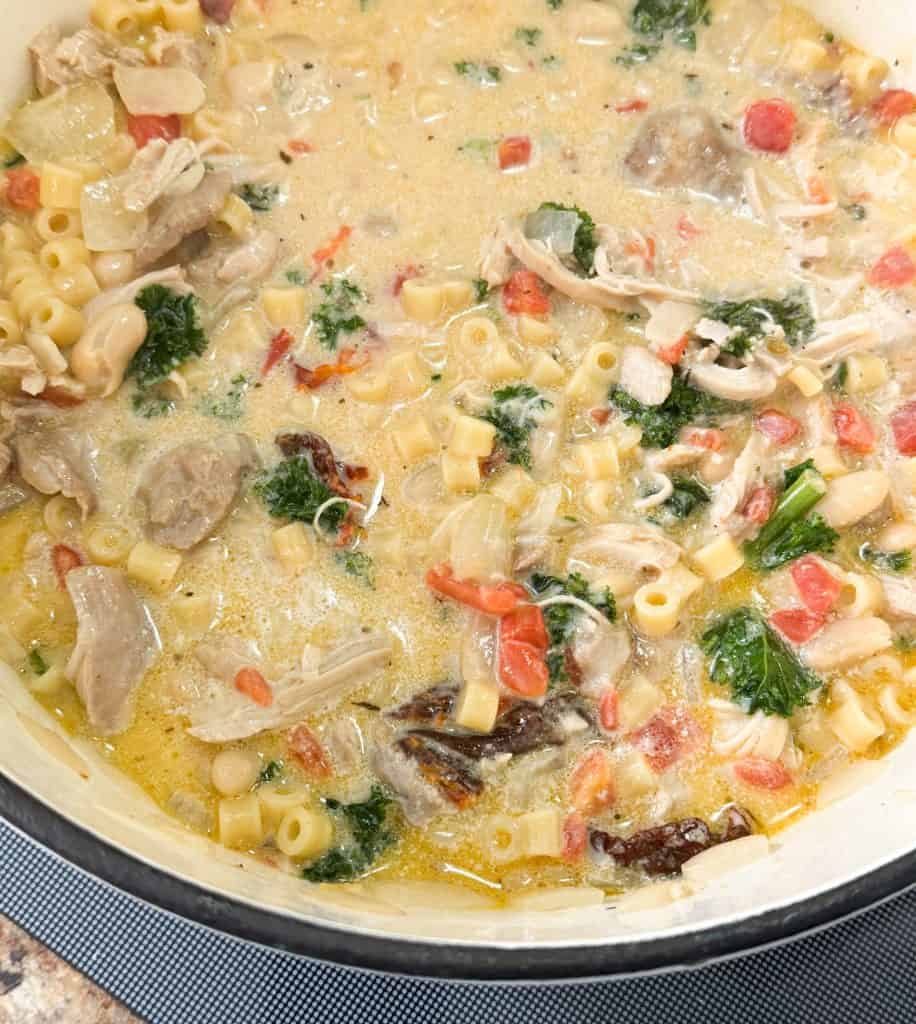 Creamy Tuscan Chicken Noodle Soup in a dutch oven