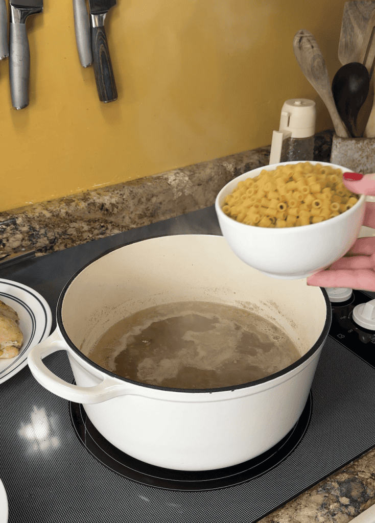 adding ditalini pasta to the large dutch oven