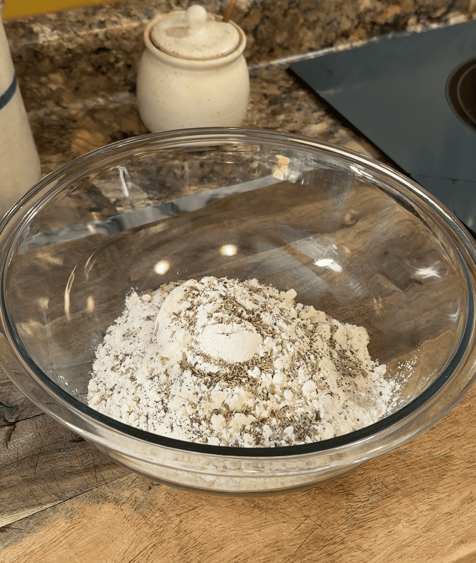 all of the dry ingredients for cheesy sausage and rosemary scones in a large mixing bowl