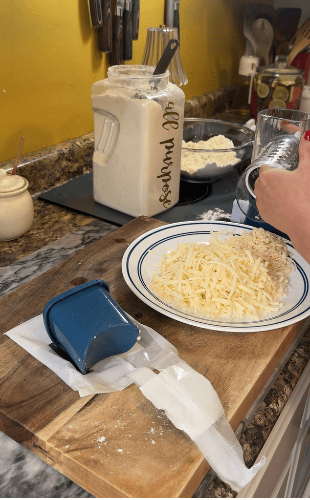 grating cheese for cheesy sausage and rosemary scones