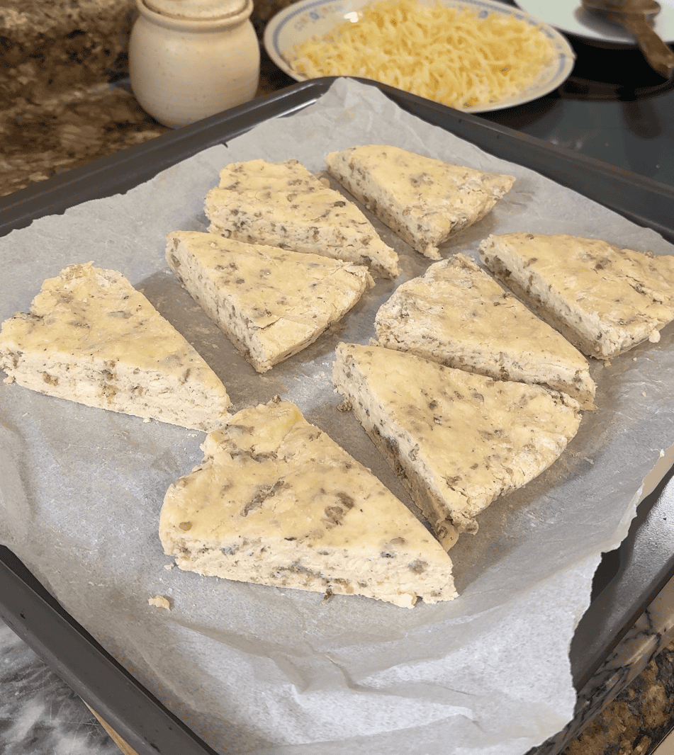 uncooked scone wedges lined on a parchment lined baking sheet