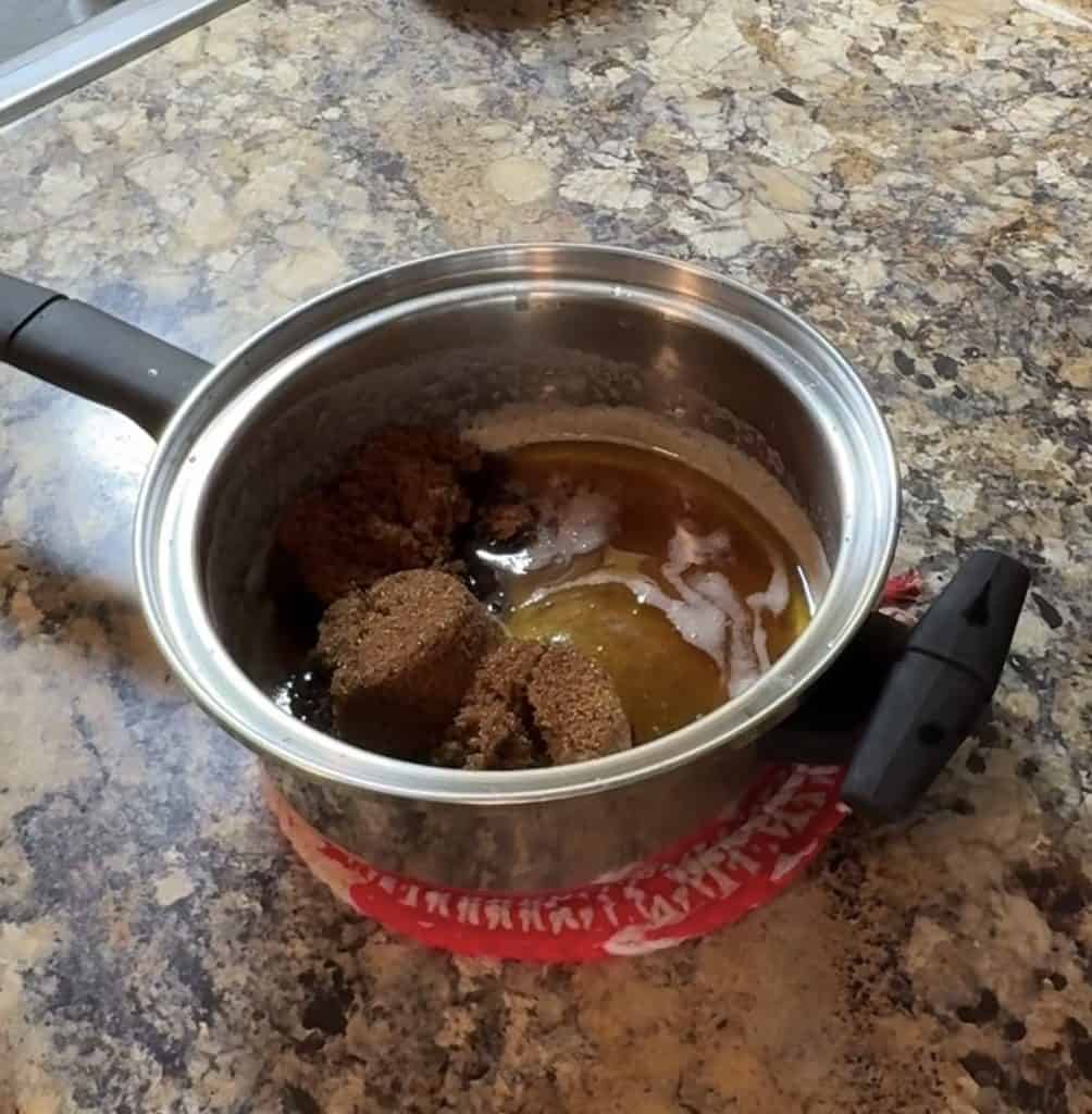 adding packed brown sugar to the browned butter in a stainless steel pot